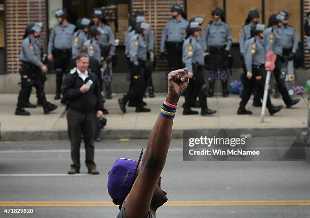 Baltimore residents celebrate at the corner of West North Avenue and Pennsylvania Avenue after Baltimore authorities released a report on the death...