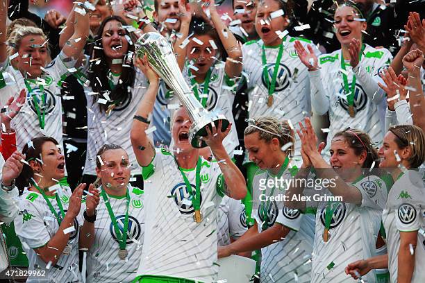 Nilla Fischer and team mates of Wolfsburg celebrate with the trophy after winning the Women's DFB Cup Final between Turbine Potsdam and VfL Wolfsburg...