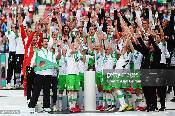 Nilla Fischer and team mates of Wolfsburg celebrate with the trophy after winning the Women's DFB Cup Final between Turbine Potsdam and VfL Wolfsburg...