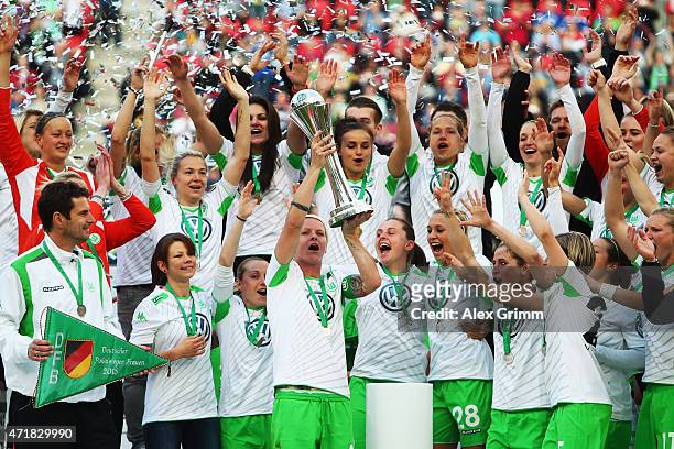 Nilla Fischer and team mates of Wolfsburg celebrate with the trophy after winning the Women's DFB Cup Final between Turbine Potsdam and VfL Wolfsburg...
