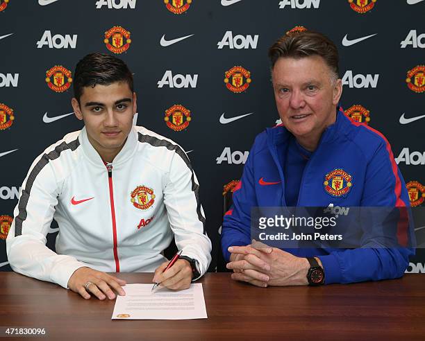 Andreas Pereira of Manchester United poses with manager Louis van Gaal after signing a contract extension at Aon Training Complex on May 1, 2015 in...