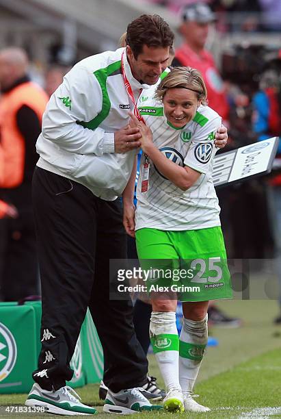 Martina Mueller of Wolfsburg is hugged by head coach Ralf Kellermann during the Women's DFB Cup Final between Turbine Potsdam and VfL Wolfsburg at...