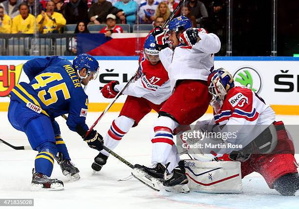 Alexander Salak , goaltender of Czech Republic stops the shot of Oscar Moller of Sweden battle for the puck during the IIHF World Championship group...