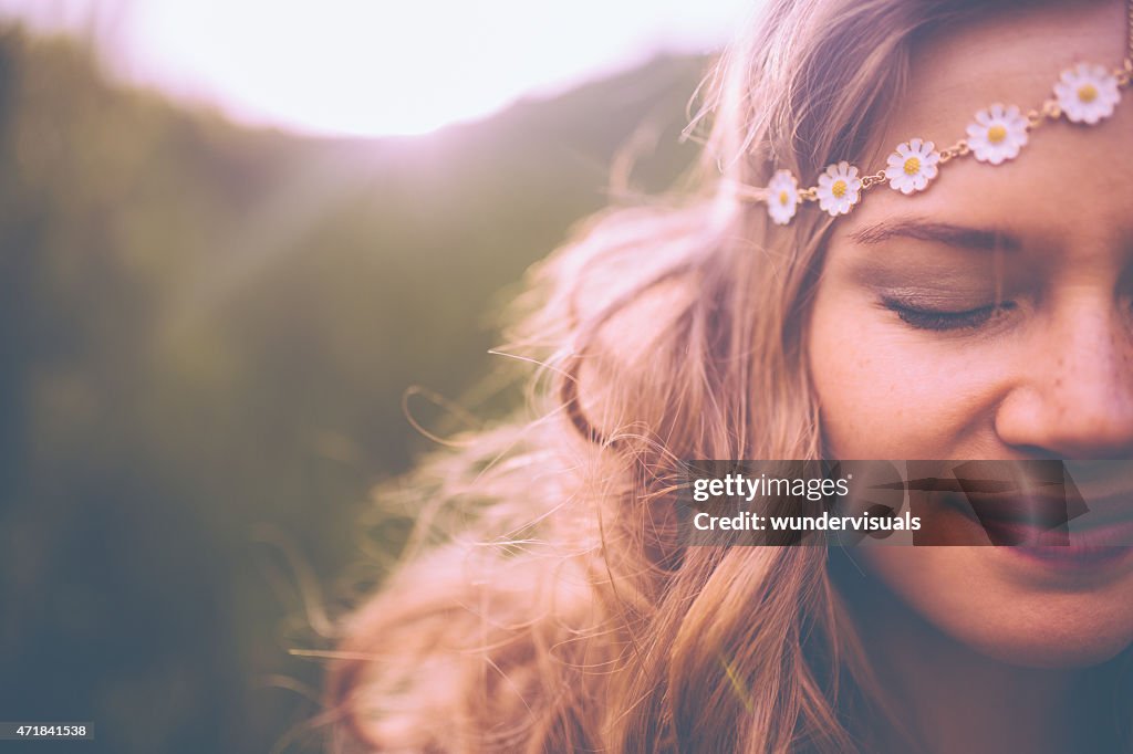 Face of a boho girl with a vintage flowered headband