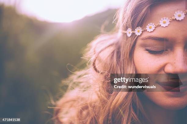 face of a boho girl with a vintage flowered headband - bohemia stock pictures, royalty-free photos & images