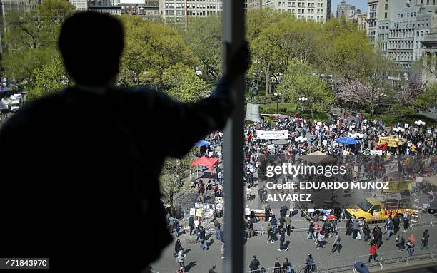 Man looks at people gathering to take part in a protest for Freddie Gray on May 1, 2015 at Union Square in New York. Baltimore, Maryland, prosecutors...