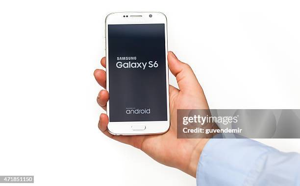 hand holding samsung galaxy s6 with clipping path on display - android phone stock pictures, royalty-free photos & images