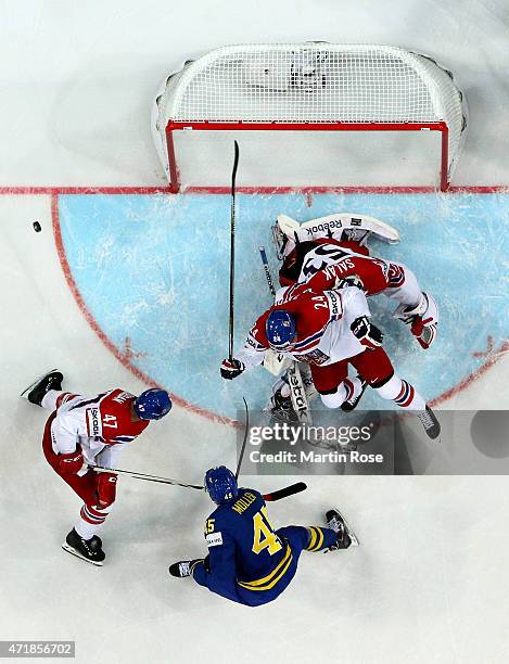 Alexander Salak , goaltender of Czech Republic stops the shot of Oscar Moller of Sweden battle for the puck during the IIHF World Championship group...