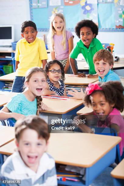 group of children in classroom - elementary age friends stock pictures, royalty-free photos & images
