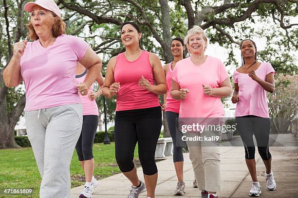 breast cancer walk - old woman running stock pictures, royalty-free photos & images