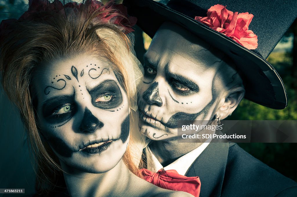 Day of the Dead couple in traditional costumes and makeup