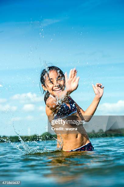 splashing water - preteen girl swimsuit stock pictures, royalty-free photos & images