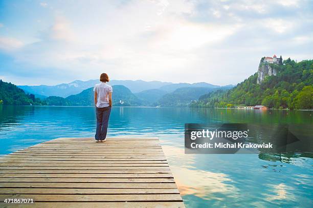 woman admiring lake - lake bled stockfoto's en -beelden