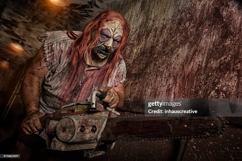 Serial Killer Clown holding chain saw