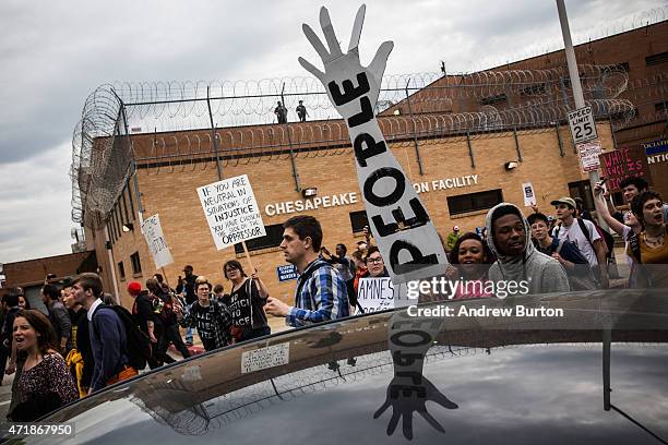 Protesters march past Chesapeake Detention Center in support of Maryland state attorney Marilyn Mosby's announcement that charges would be filed...