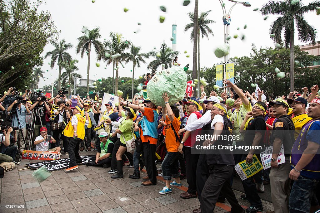 Demonstrators throw papier mache "guavas" legislature...