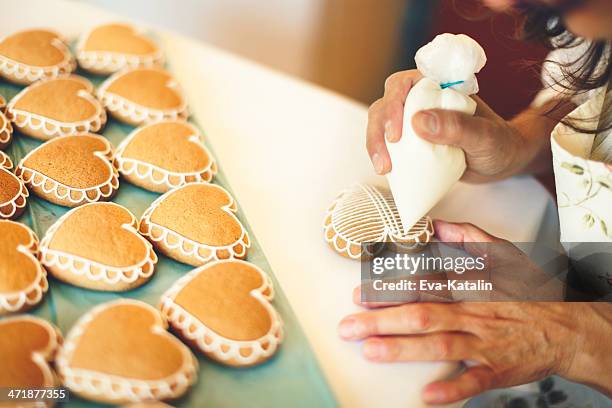 portrait of a gingerbread maker - decorating cookies stock pictures, royalty-free photos & images