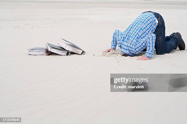 office worker hiding head in sand - financial fear stock pictures, royalty-free photos & images