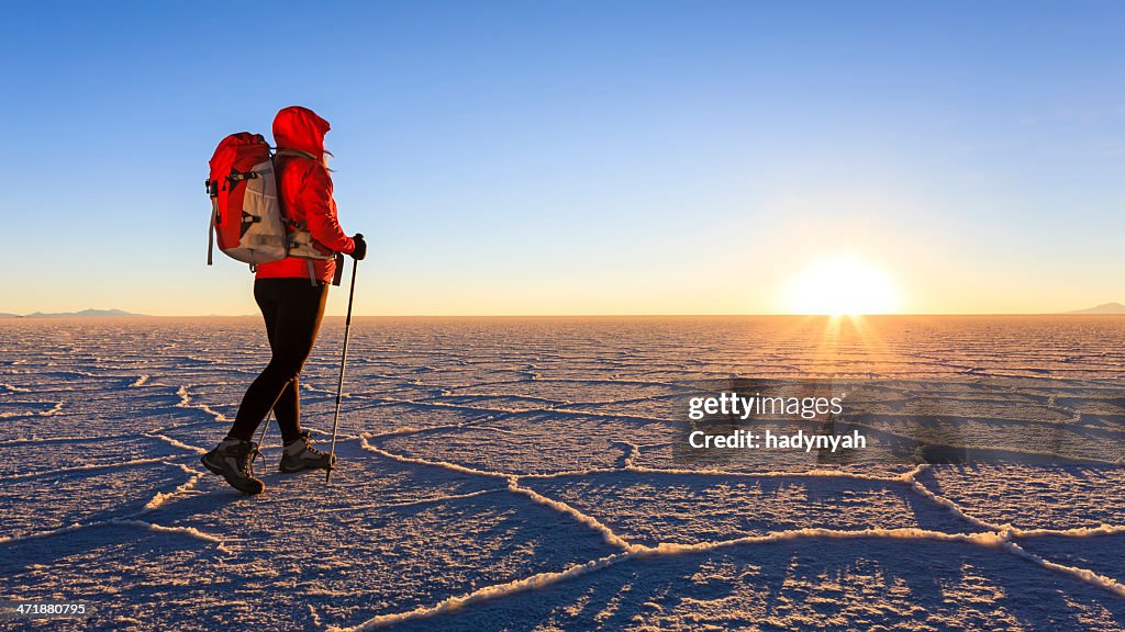 Female tourist on Salar de Uyuni during sunset, Altiplano Bolivia