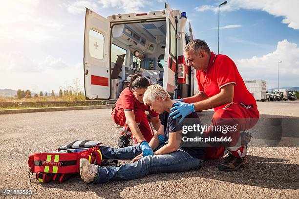 medical emergency team arrives at street accident - red crescent stock pictures, royalty-free photos & images