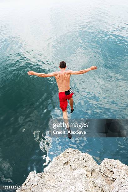 risk taking - wild swimming stock pictures, royalty-free photos & images