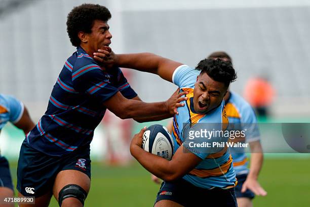 Lona Holaholo of Mount Albert Grammar is tackled by Hoskins Sotutu of Sacred Heart during the Schoolboys Rugby match between MAGS and Sacred Heart at...