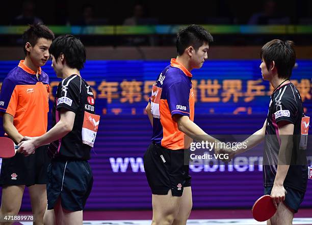 Zhou Yu and Fan Zhendong of China shake hands with Kenta Matsudaira and Koki Niwa of Japan during men's doubles semi-final match on day seven of the...