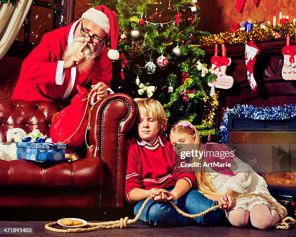 children fallen asleep trying to catch santa claus - naughty santa stock pictures, royalty-free photos & images