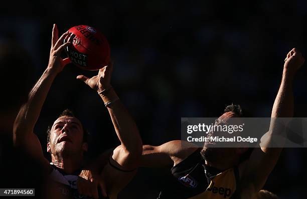 Josh Walker of the Cats marks the ball against Troy Chaplin of the Tigers during the round five AFL match between the Richmond Tigers and the Geelong...