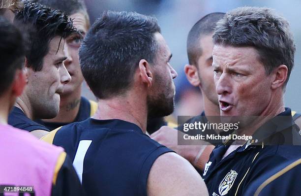 Tigers head coach Damien Hardwick speaks to his players at three quarter time during the round five AFL match between the Richmond Tigers and the...