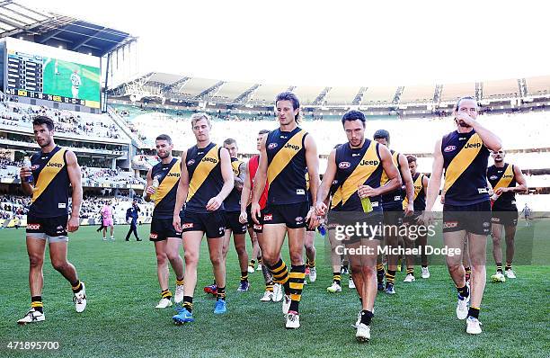 Tigers players walk off after defeat during the round five AFL match between the Richmond Tigers and the Geelong Cats at Melbourne Cricket Ground on...