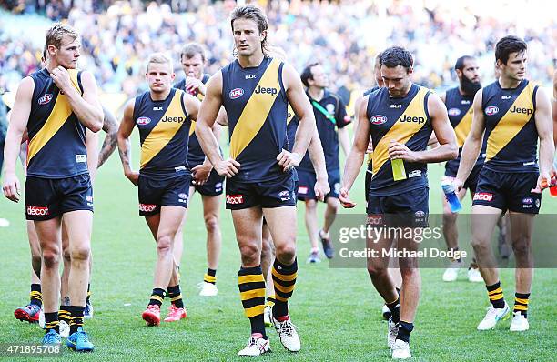 Ivan Maric of the Tigers and teamates walk off after defeat during the round five AFL match between the Richmond Tigers and the Geelong Cats at...