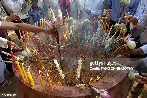 Cambodians pray during the Visak Bochea at the Oddong mountain in Kandal province on May 2, 2015. Thousands of Cambodians celebrate 2,559 years of...