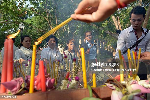 Cambodians pray during the Visak Bochea at the Oddong mountain in Kandal province on May 2, 2015. Thousands of Cambodians celebrate 2,559 years of...