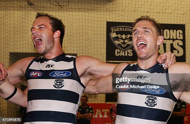 Josh Walker of the Cats and Joel Selwood sing the club song after winning during the round five AFL match between the Richmond Tigers and the Geelong...