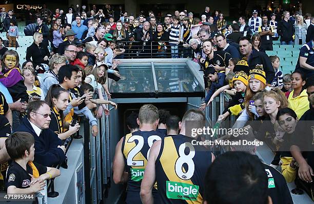 Tigers players walk off after defeat during the round five AFL match between the Richmond Tigers and the Geelong Cats at Melbourne Cricket Ground on...