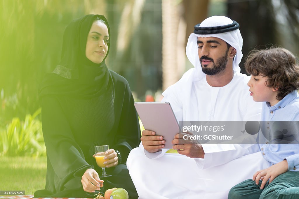 An Arab family with their son in a park