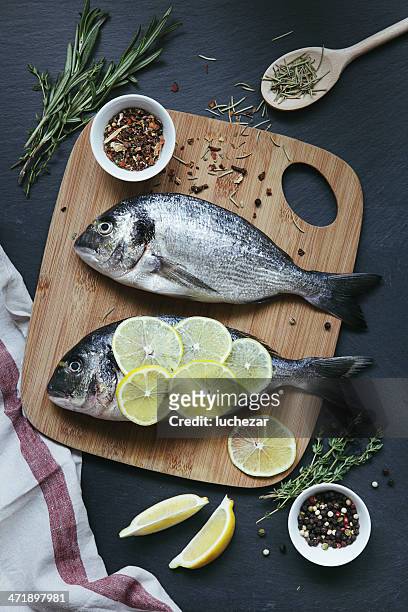 dorado with lemon and spices - dolphin fish stock pictures, royalty-free photos & images