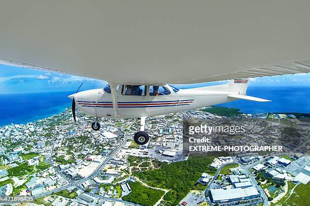 flying airplane - george town grand cayman stock pictures, royalty-free photos & images