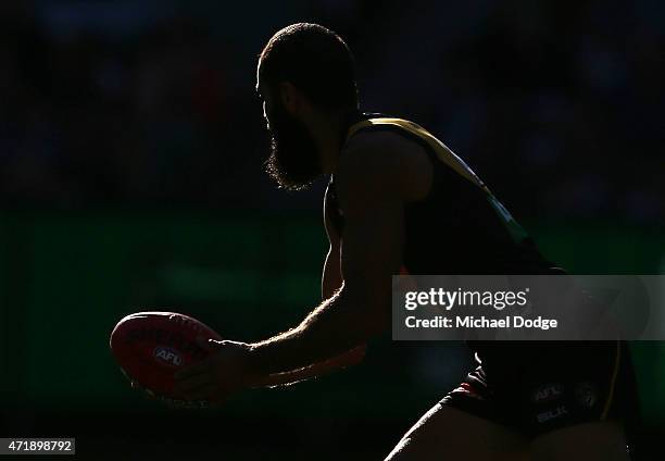 Bachar Houli of the Tigers runs with the ball during the round five AFL match between the Richmond Tigers and the Geelong Cats at Melbourne Cricket...