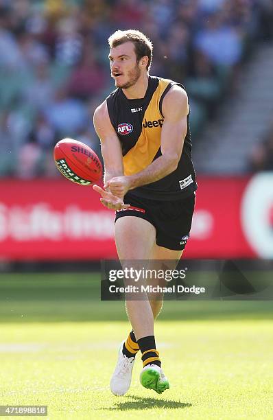 Kamdyn McIntosh of the Tigers handballs during the round five AFL match between the Richmond Tigers and the Geelong Cats at Melbourne Cricket Ground...