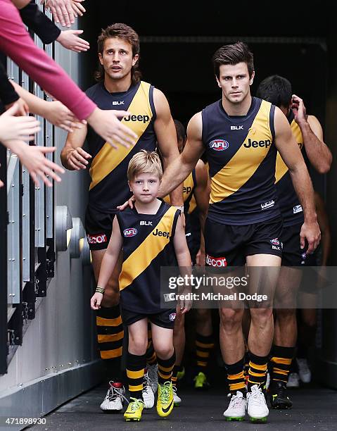 Trent Cotchin of the Tigers leads the team during the round five AFL match between the Richmond Tigers and the Geelong Cats at Melbourne Cricket...