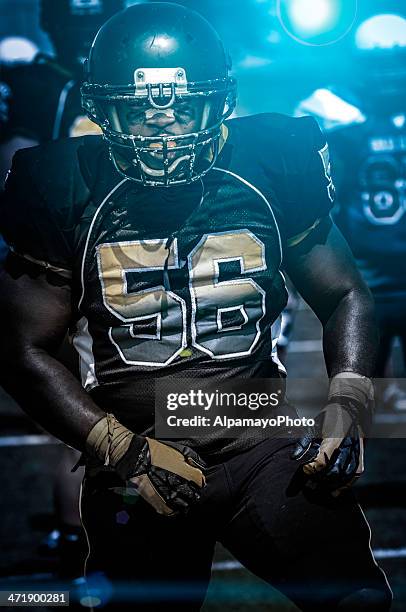 football play in progress - night time (xx) - collegiate defensive player stock pictures, royalty-free photos & images