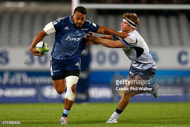 George Moala of the Blues is tackled by Kyle Godwin of the Western Force during the round 12 Super Rugby match between the Blues and the Force at...