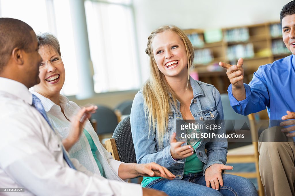 Diverse group of people talking during support meeting