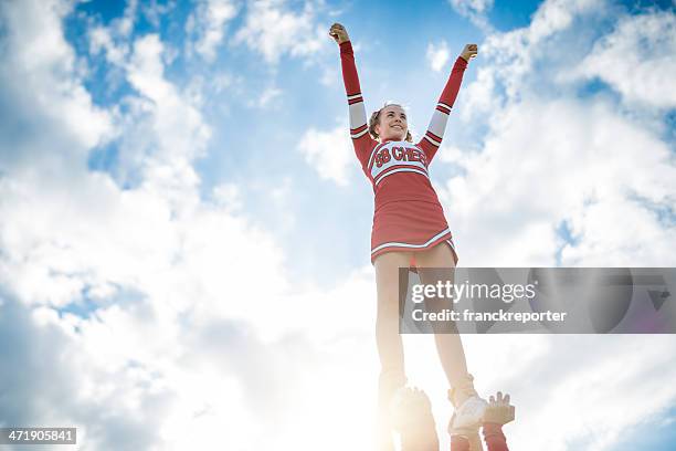 cheerleadear on top of the success - human pyramid stock pictures, royalty-free photos & images