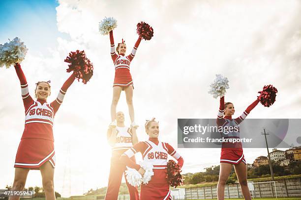 happiness cheerleaders posing with pon-pon - teen cheerleader 個照片及圖片檔