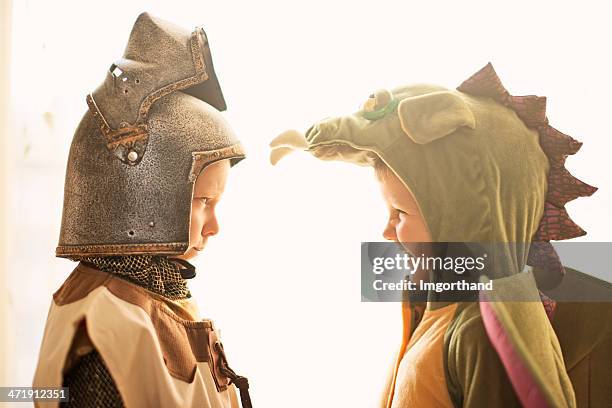 mortal enemies - knight and dragon. - period costume stock pictures, royalty-free photos & images