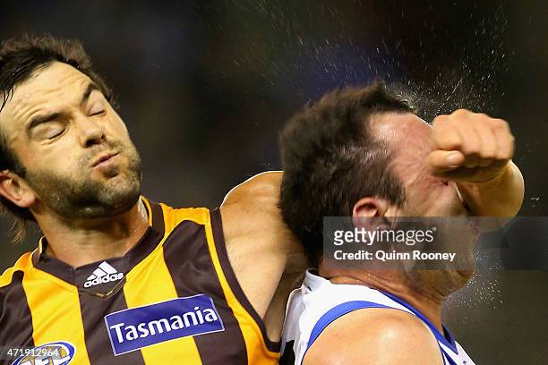 Jordan Lewis of the Hawks collects Todd Goldstein of the Kangaroos in the head as he attempts to spoil during the round five AFL match between the...