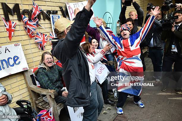 Royal fans celebrate outside the Lindo wing at St Mary's hospital in central London, on May 2, 2015 after the news is passed that Catherine, Duchess...